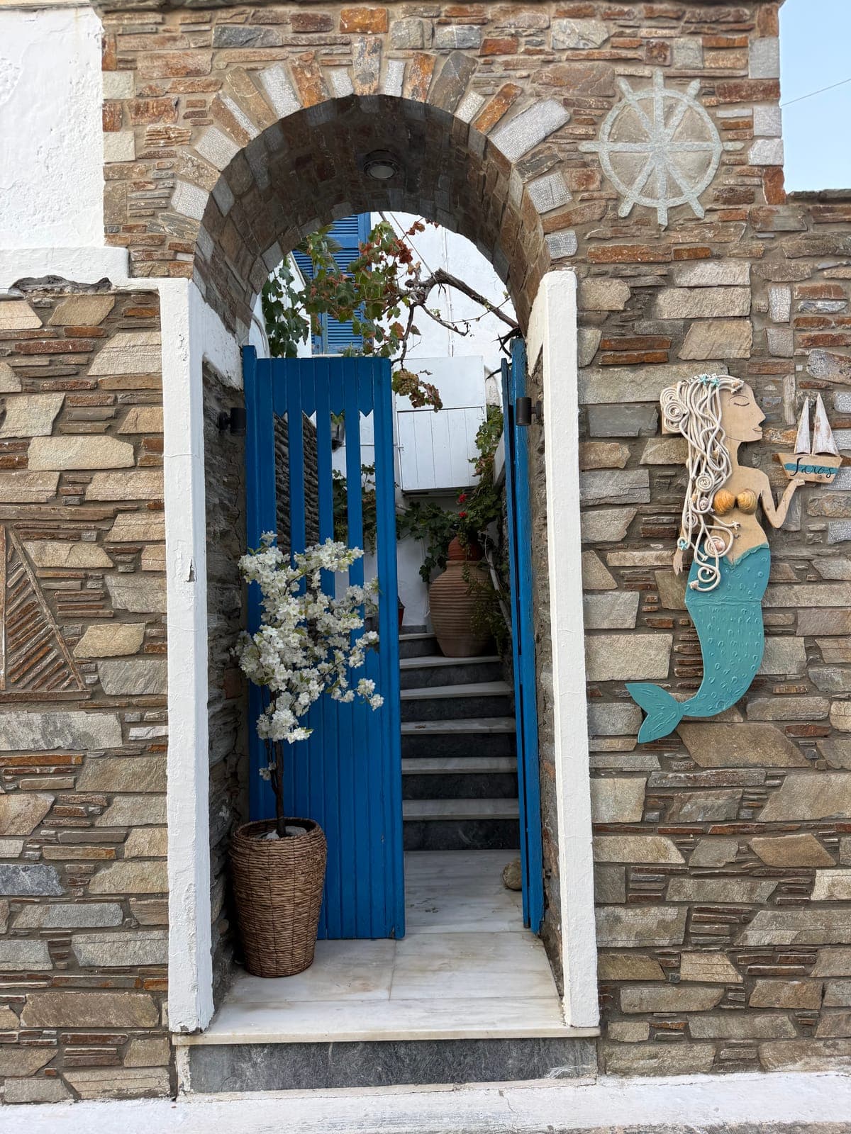 Blue door and mermaid tiles on Andros