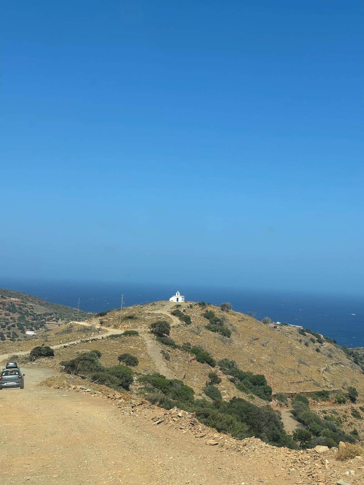 A white chapel on a hill above the sea