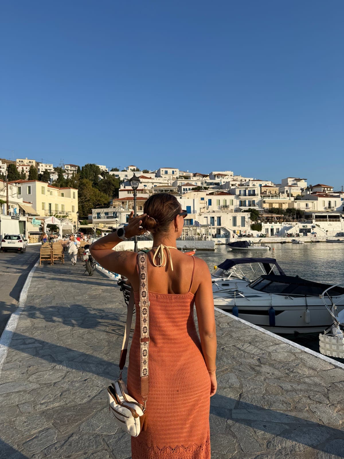 Katarina walking along an island harbor